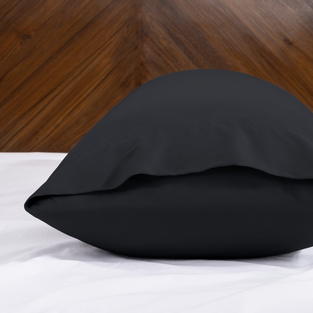 Body pillowcase with an envelope closure on a bed with a wooden headboard