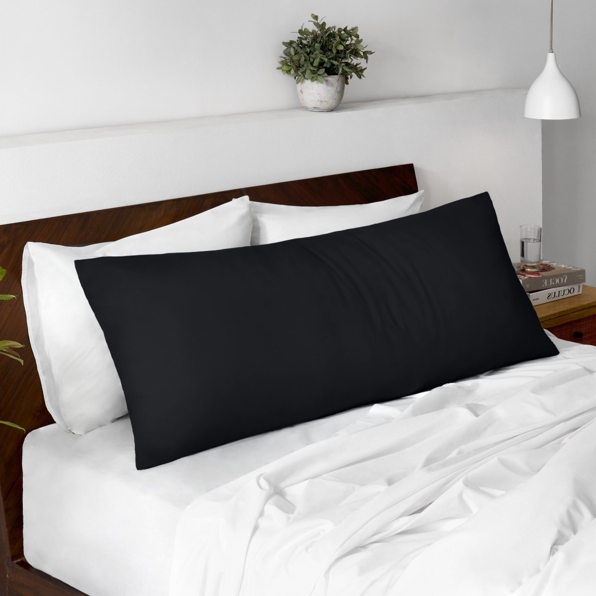 Body pillow on a bed with a wooden headboard and minimal decor.
