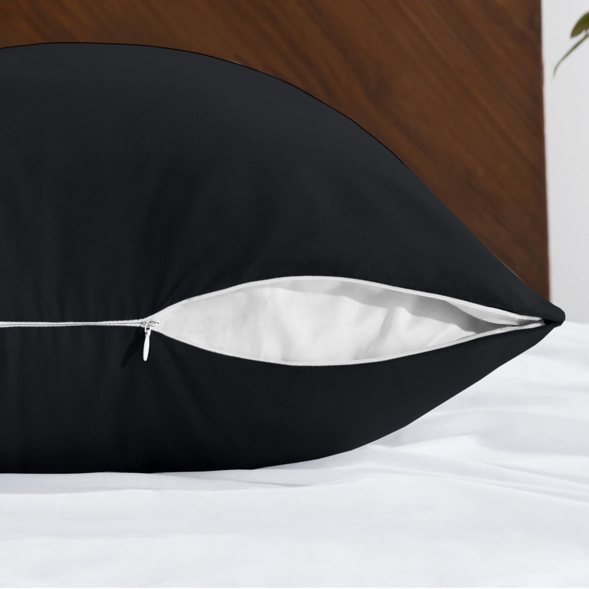 Body pillowcase with a zipper closure on a bed with a wooden headboard