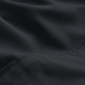 A close-up of microfiber fabric with soft folds and a visible stitched seam.