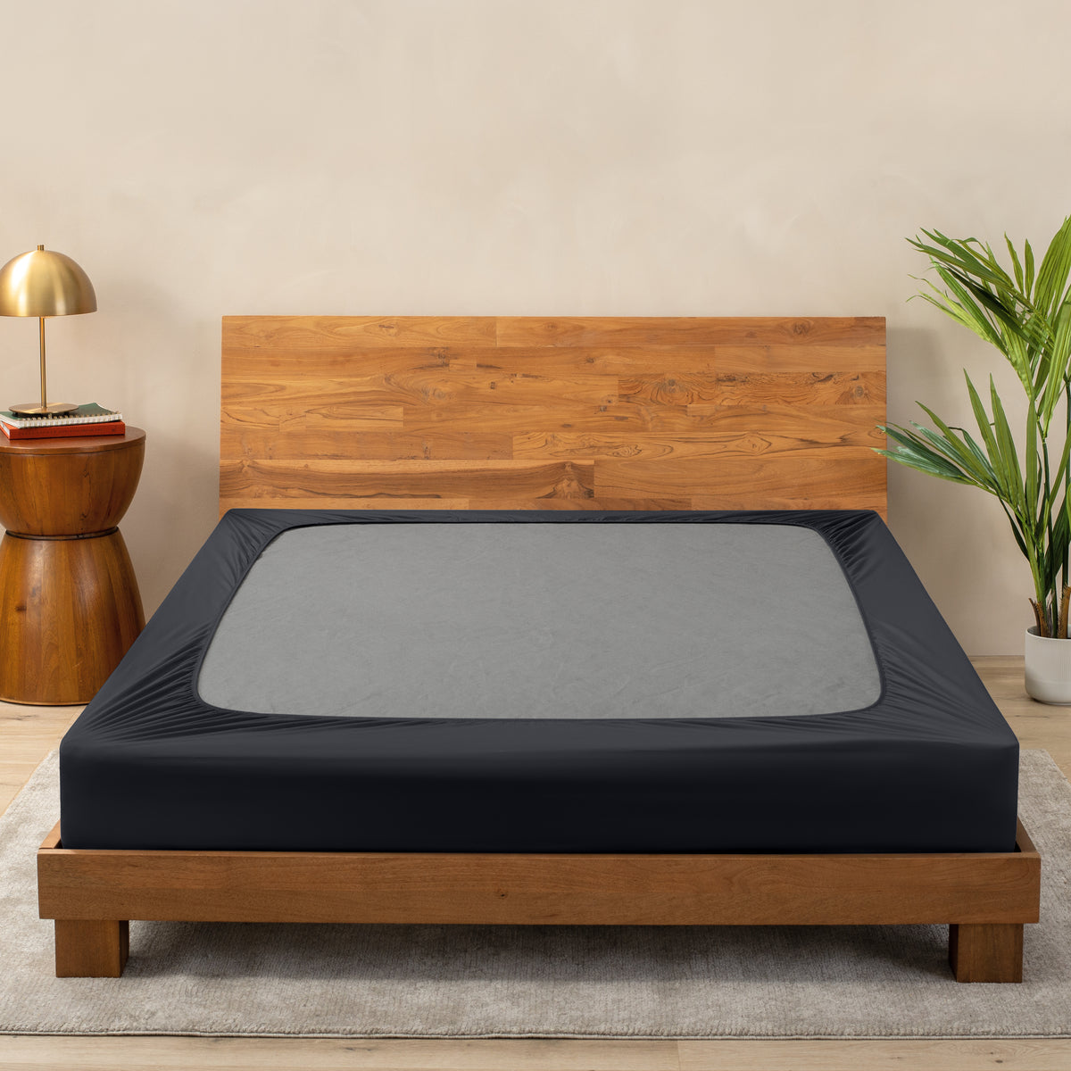 A cover on a box spring set on a wooden bed frame