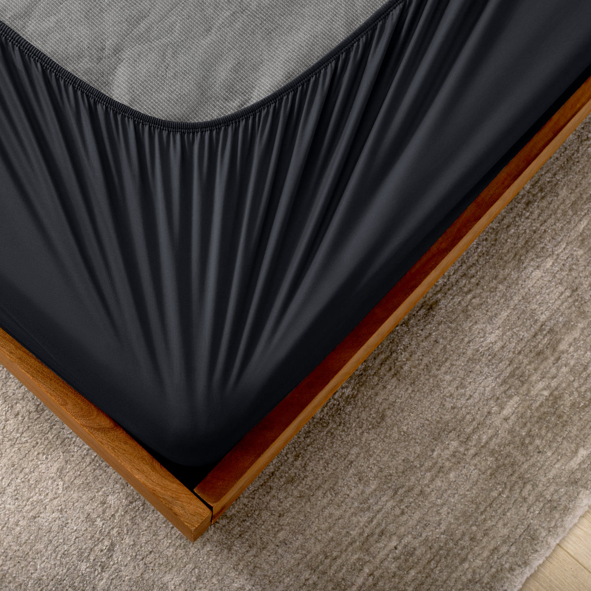 The corner of a box spring with a cover on it