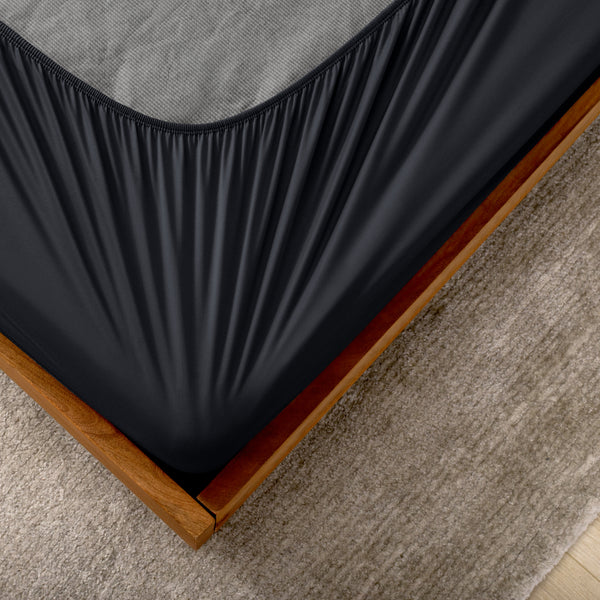 The corner of a box spring with a cover on it