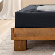 Close up of the corner of a bed frame with a cover box spring 