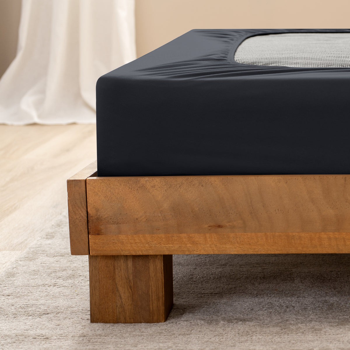 Close up of the corner of a bed frame with a cover box spring 