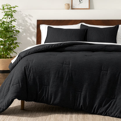 Bedding set on a bed in a bedroom with a side table and lamp.