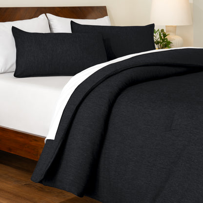 Track stitch comforter on a bed with white pillows and a wooden headboard.