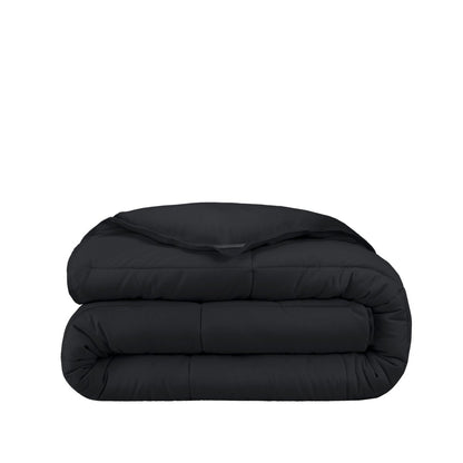 Folded black comforter on a white background