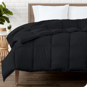 A modern bedroom with a duvet insert on a bed folded back over itself