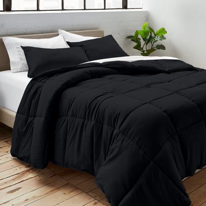 Comforter on a bed with white pillows and a plant in the corner.