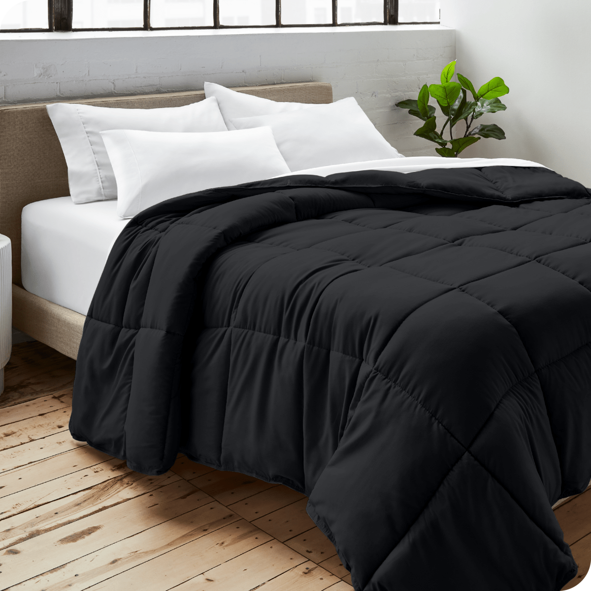A bedroom with a duvet insert, pillowcases and shams on the bed
