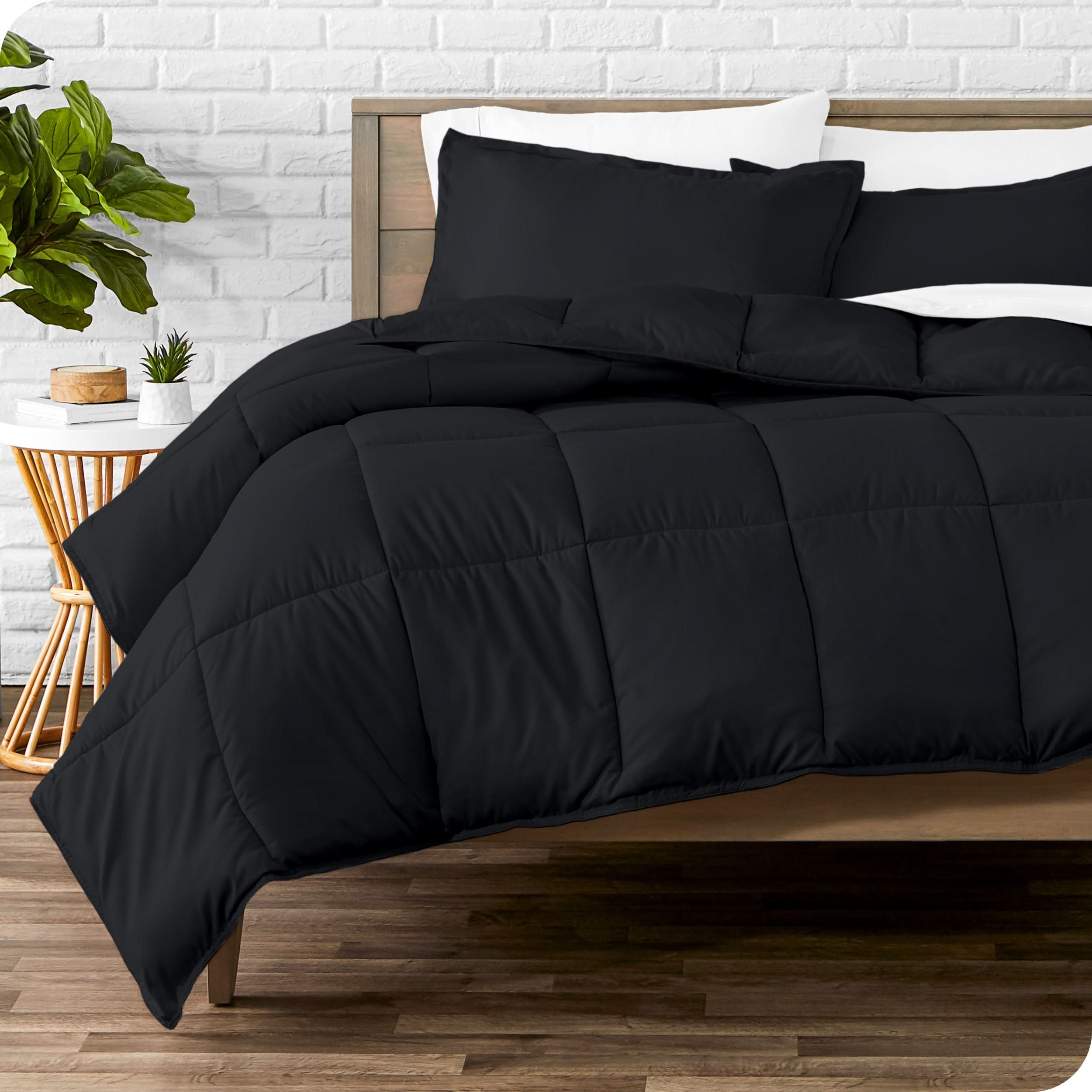 A modern bed with a down alternative comforter set on it