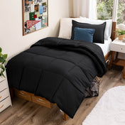 Comforter set on a bed in a bedroom with a window and decor.