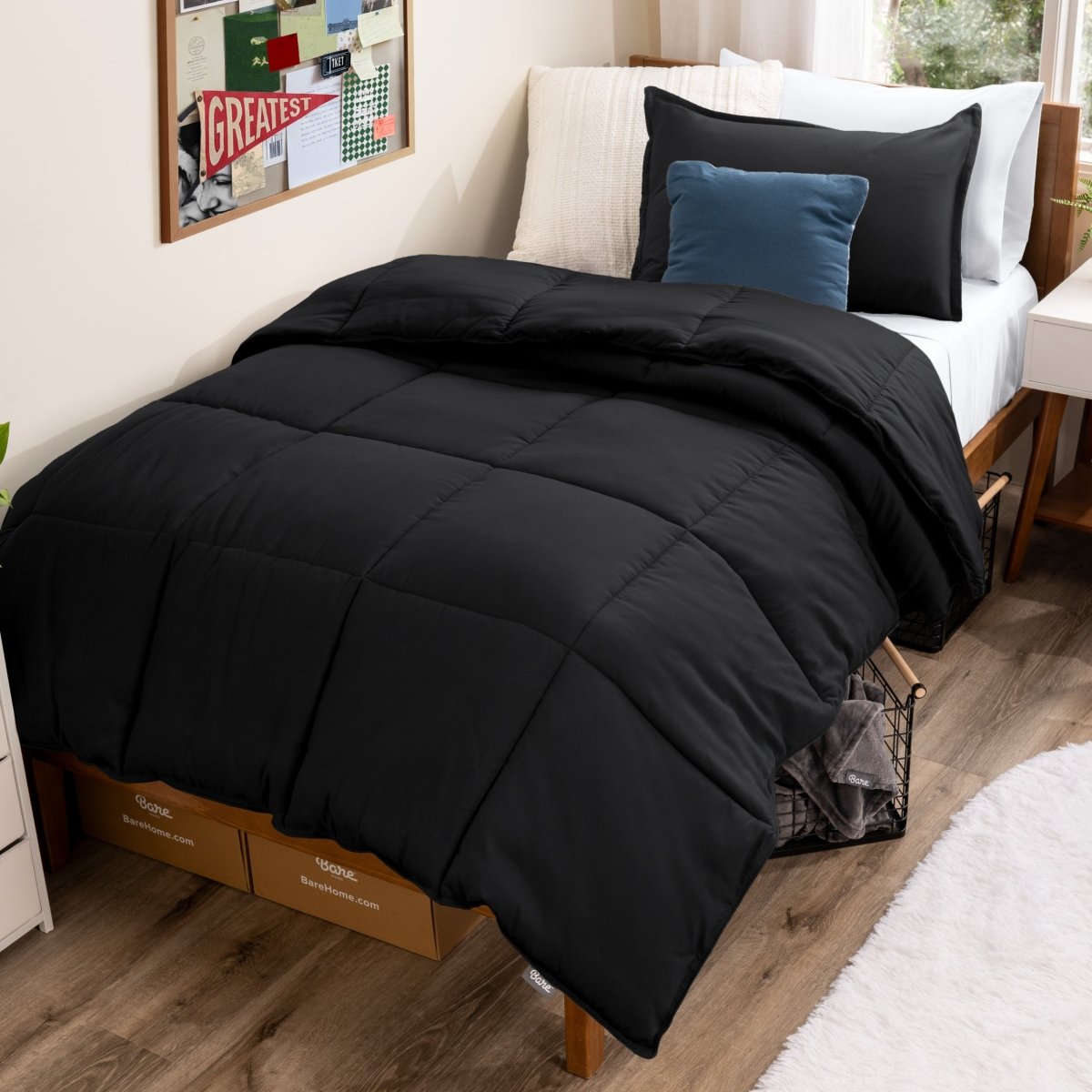 Bed with comforter and pillows in a dorm room