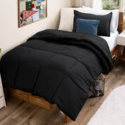 Bed with comforter and pillows in a dorm room
