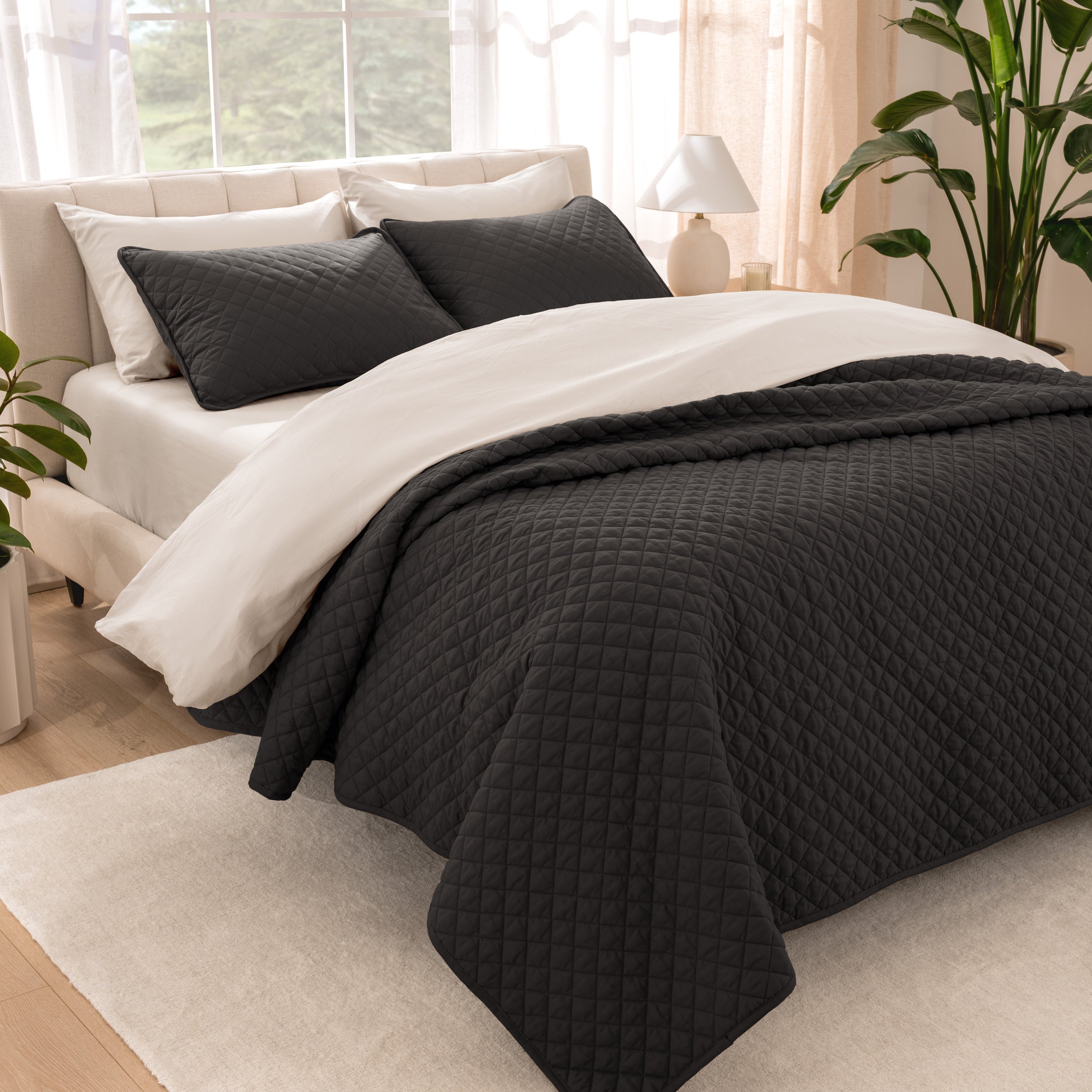 Bedroom showing coverlet set laying on the bed with the quilt folded over on itself