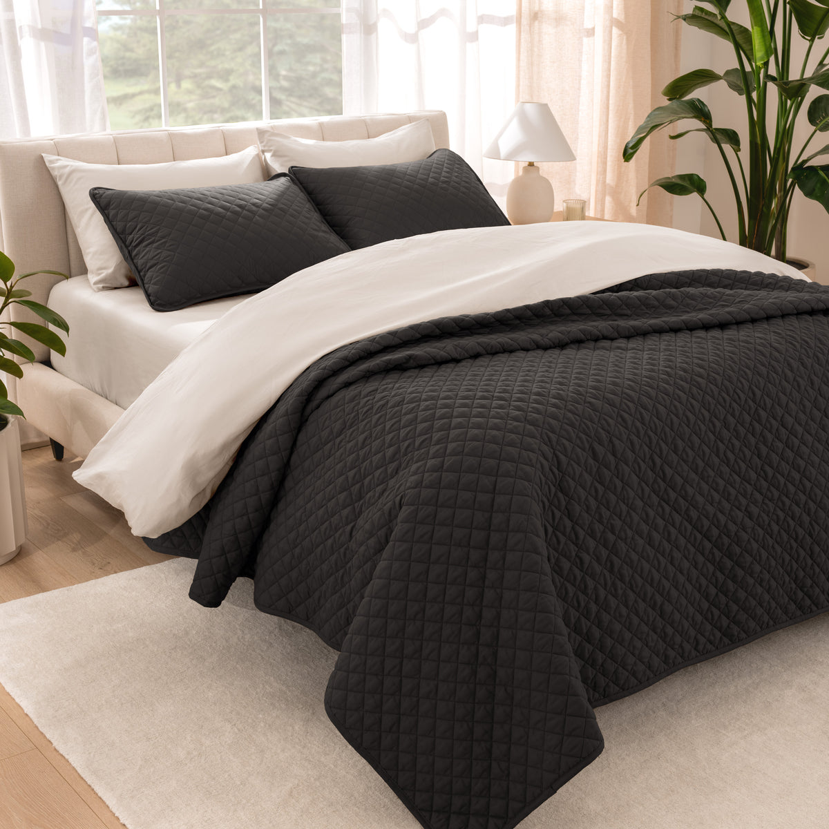Bedroom showing coverlet set laying on the bed with the quilt folded over on itself
