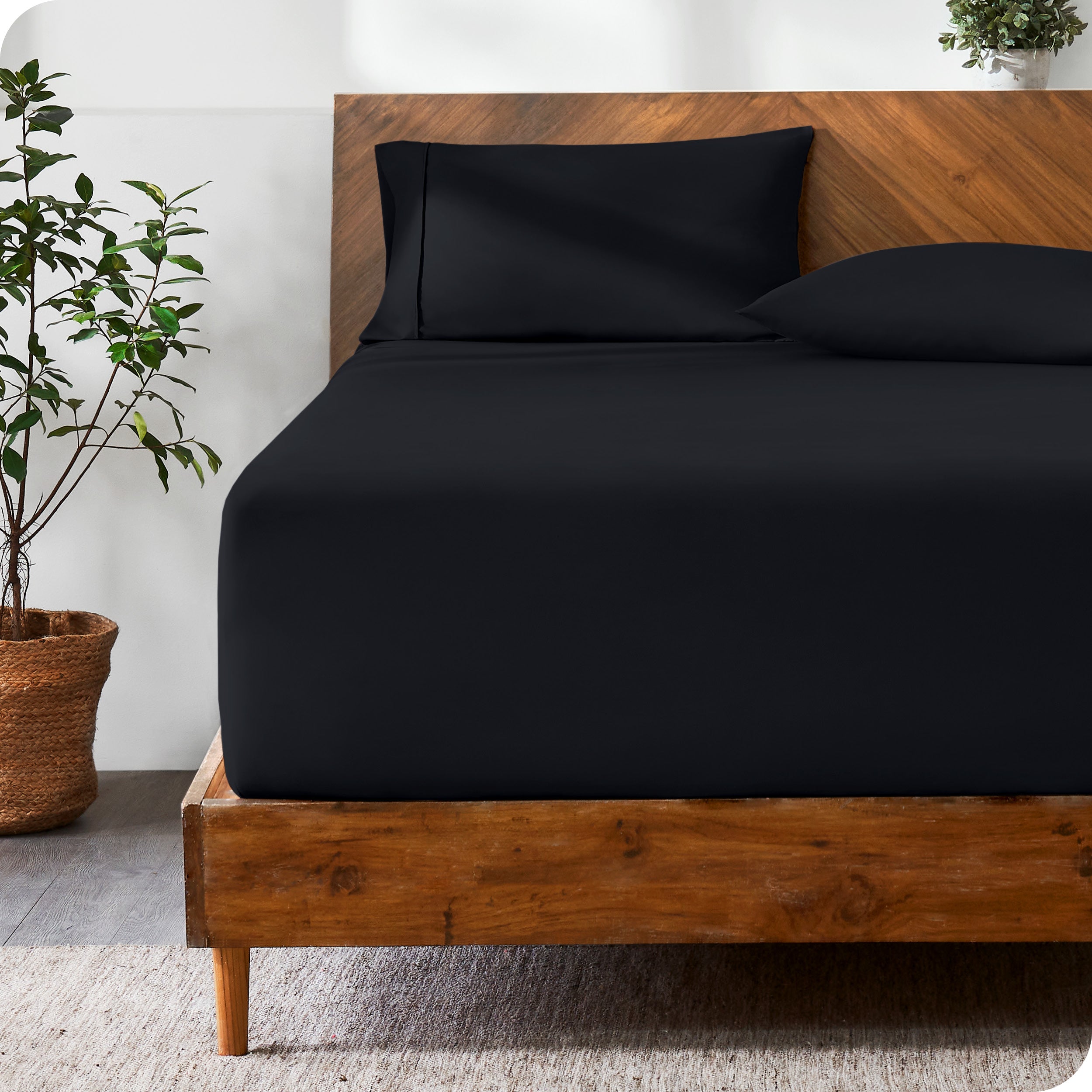 Wooden bed with ultra soft bedding in a minimalistic room.