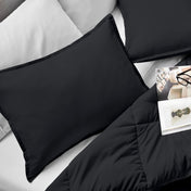 Microfiber pillow sham set on a bed with a magazine on top of the comforter.
