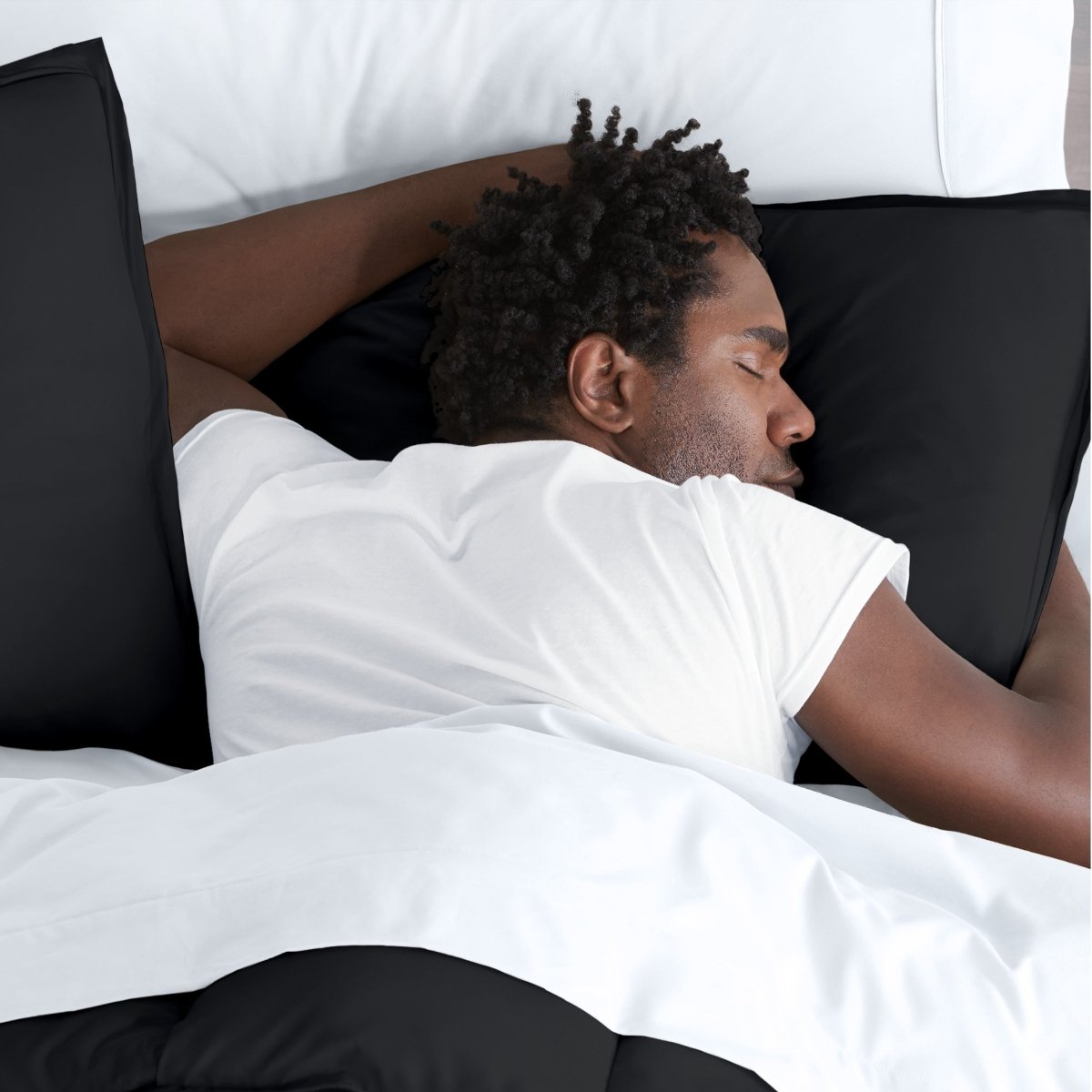 Man sleeping on a bed with microfiber bedding