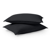Two pillows stacked on a white background