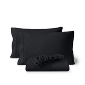 Pillowcases and a matching fitted sheet folded in front, shown on a plain white background.