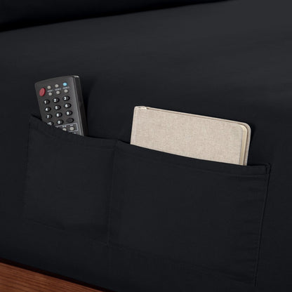 Remote control and journal in the pockets of a fitted sheet