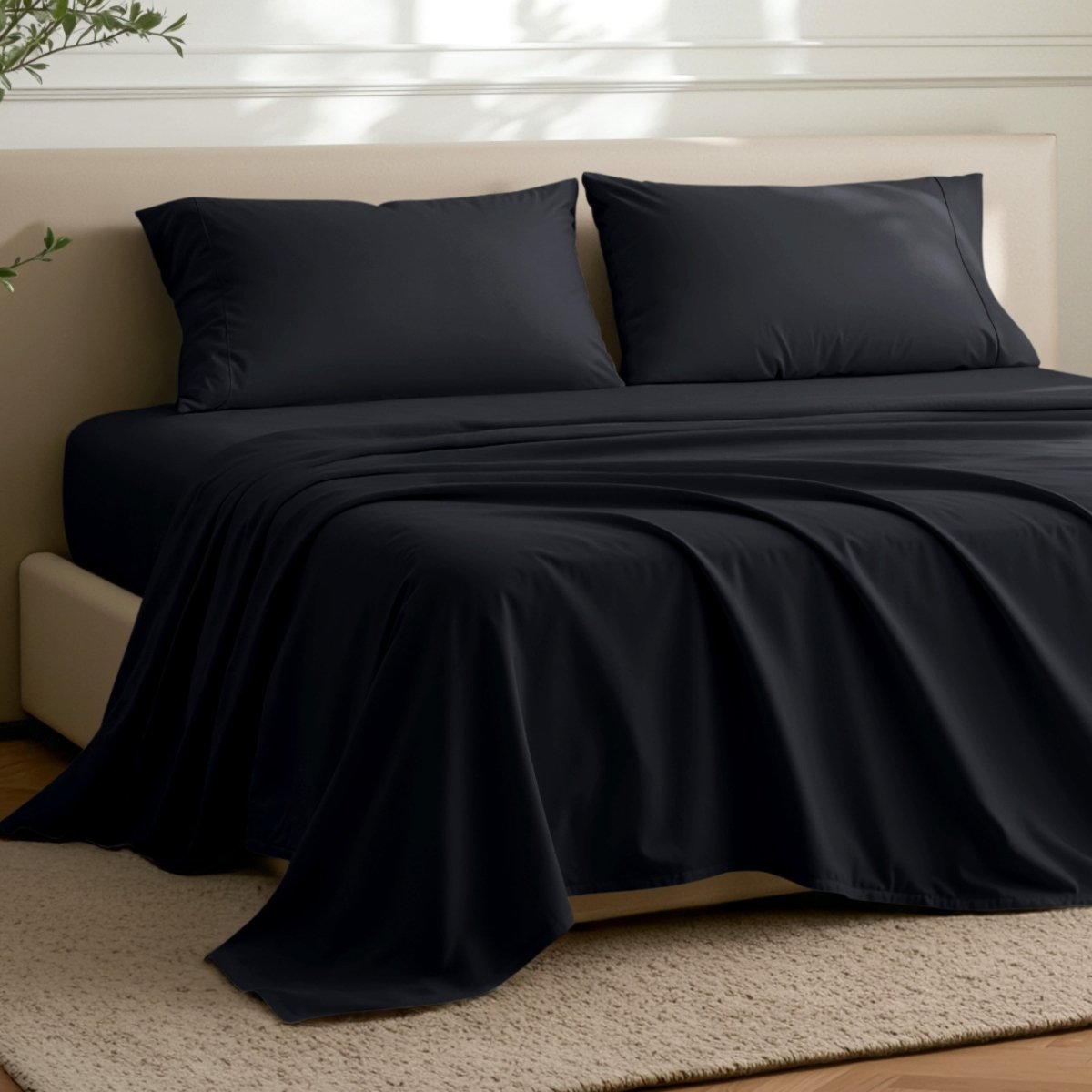 Microfiber flat sheet on a bed in a bedroom with a plant.