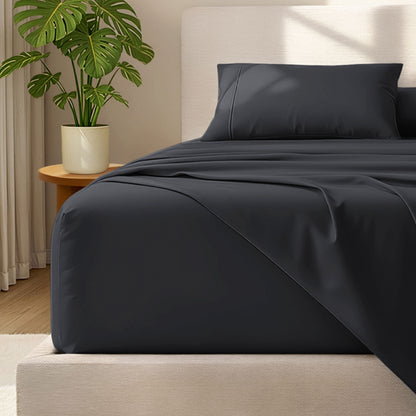 Bed with microfiber bedding and wooden headboard in a bedroom setting