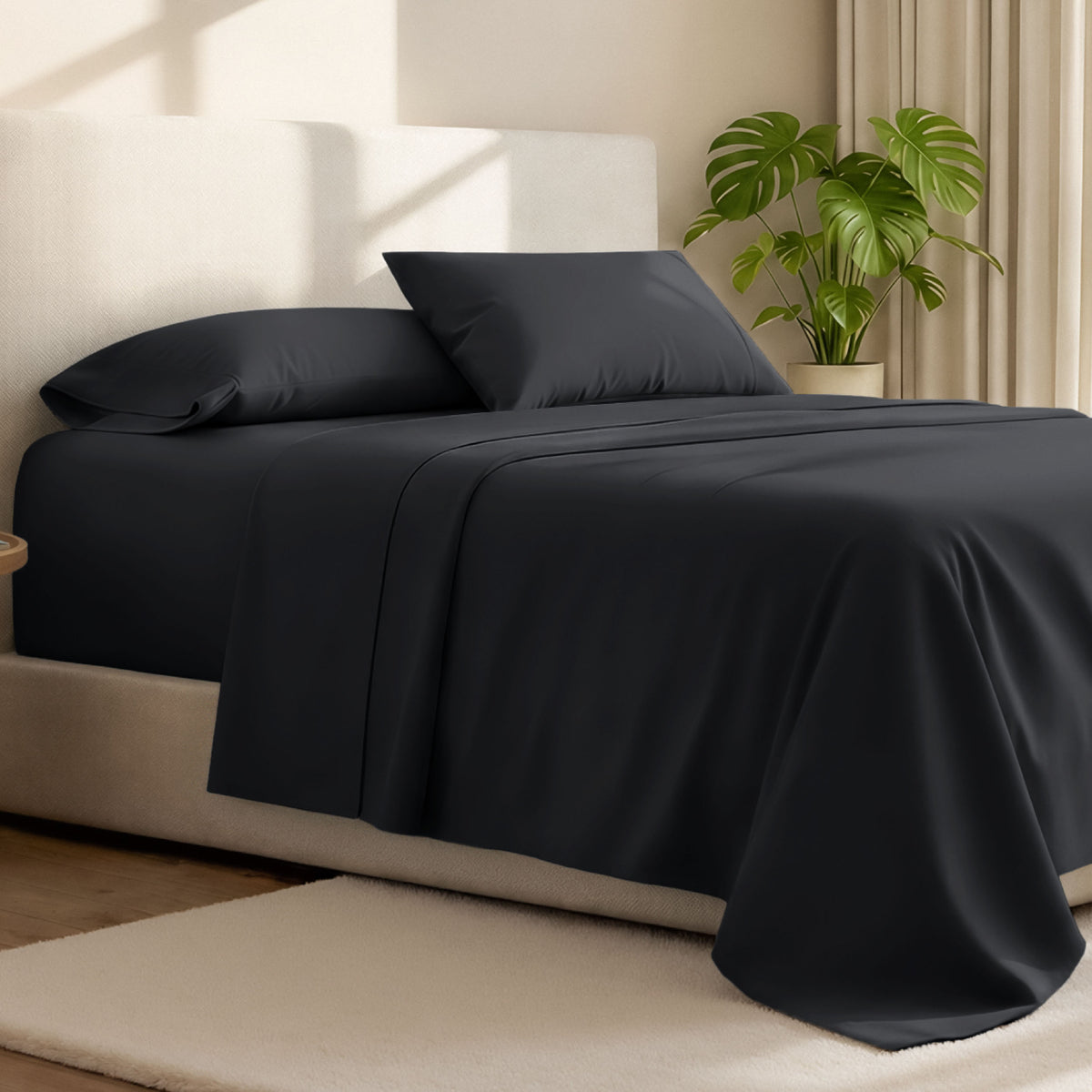 Microfiber bed sheets on a neatly made bed with a wooden headboard and nightstand.