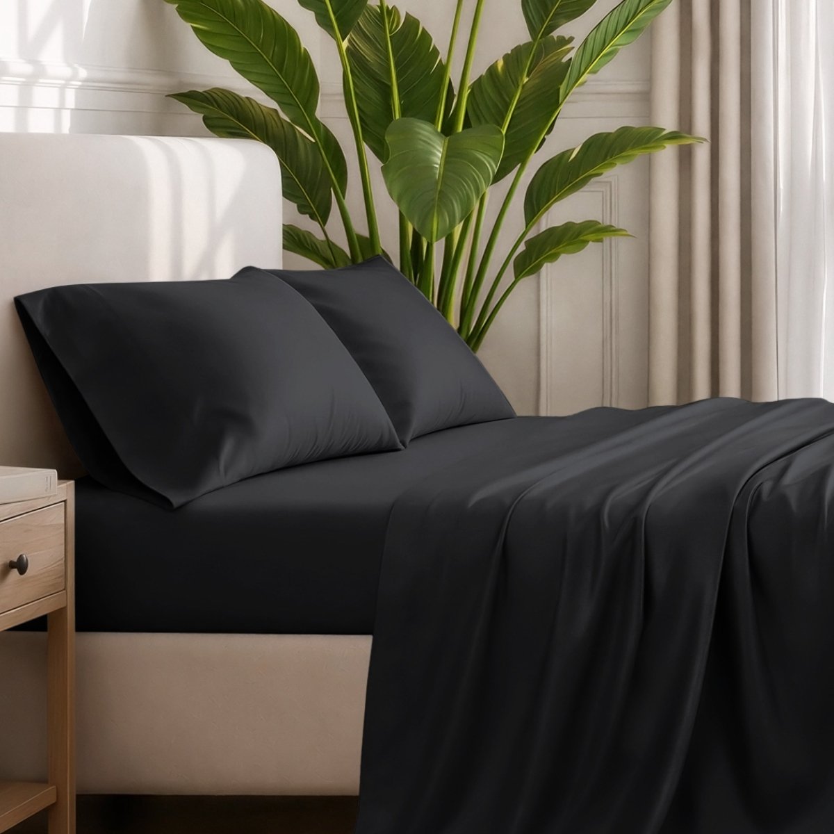 Ultra-soft sheets and pillowcases on a bed with a plant in the background