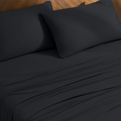 Bed sheets and pillowcases on a bed with a wooden headboard