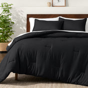 Bedding set on a bed in a bedroom with a side table and lamp.
