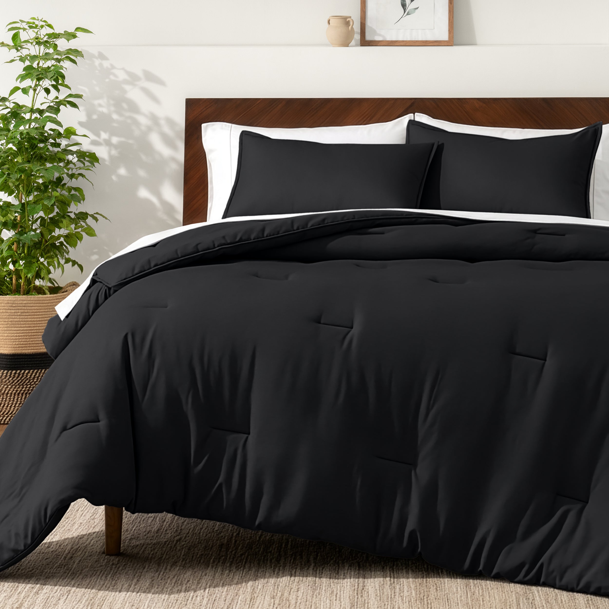 Bedding set on a bed in a bedroom with a side table and lamp.