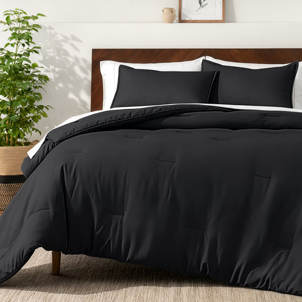 Bedding set on a bed in a bedroom with a side table and lamp.