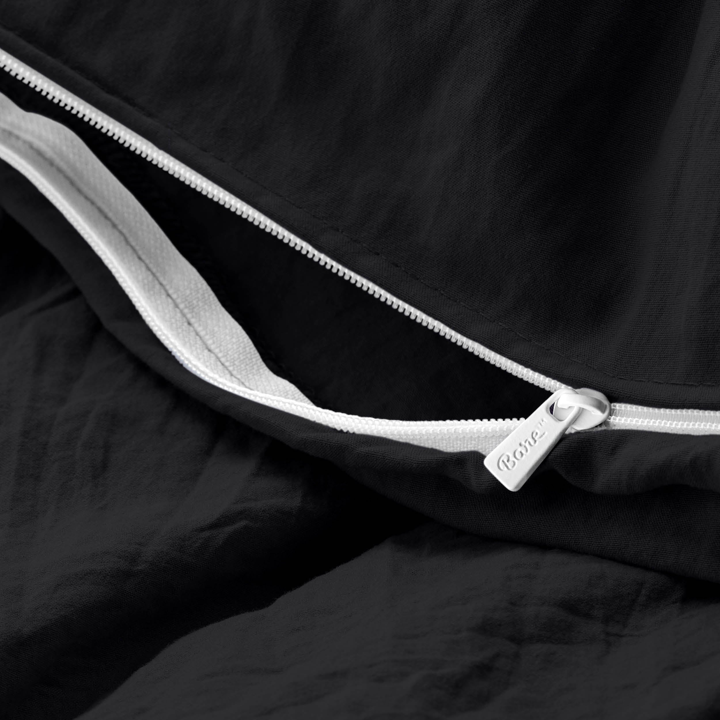 Close-up of a duvet cover with a zipper, featuring the brand Bare Home