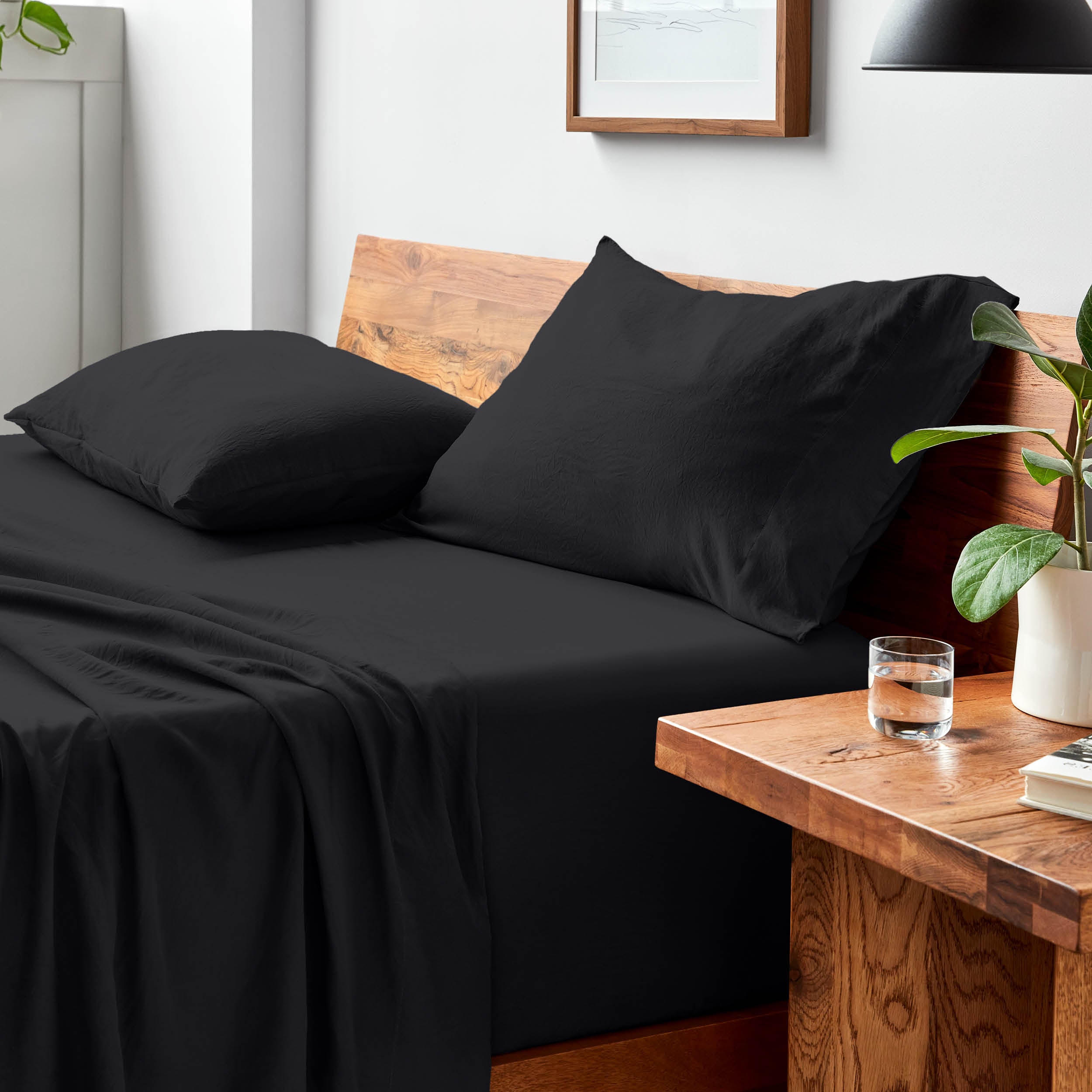 Bed with microfiber bedding and pillows in a bedroom setting