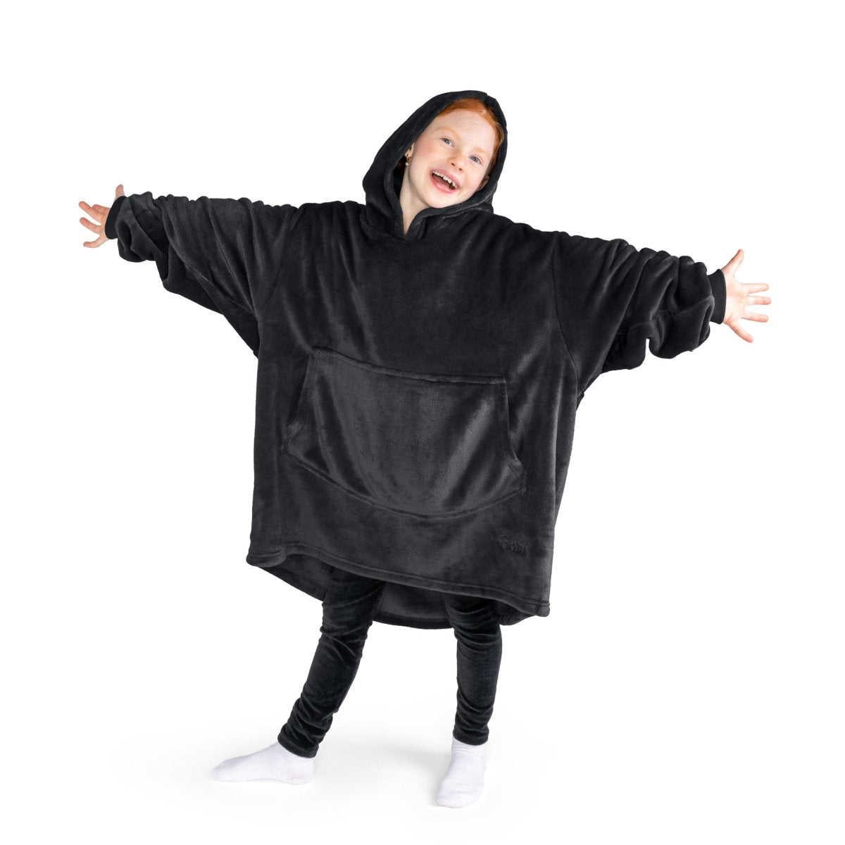 A child has a hooded microplush wearable blanket on and her arms are stretched out