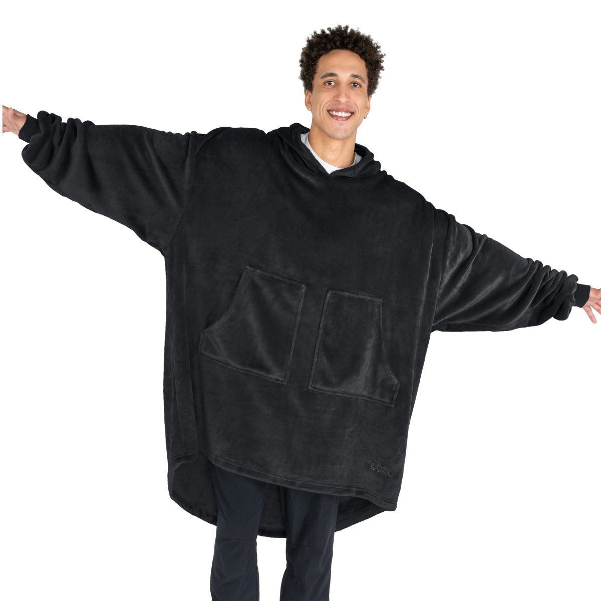 An adult with microplush wearable blanket on