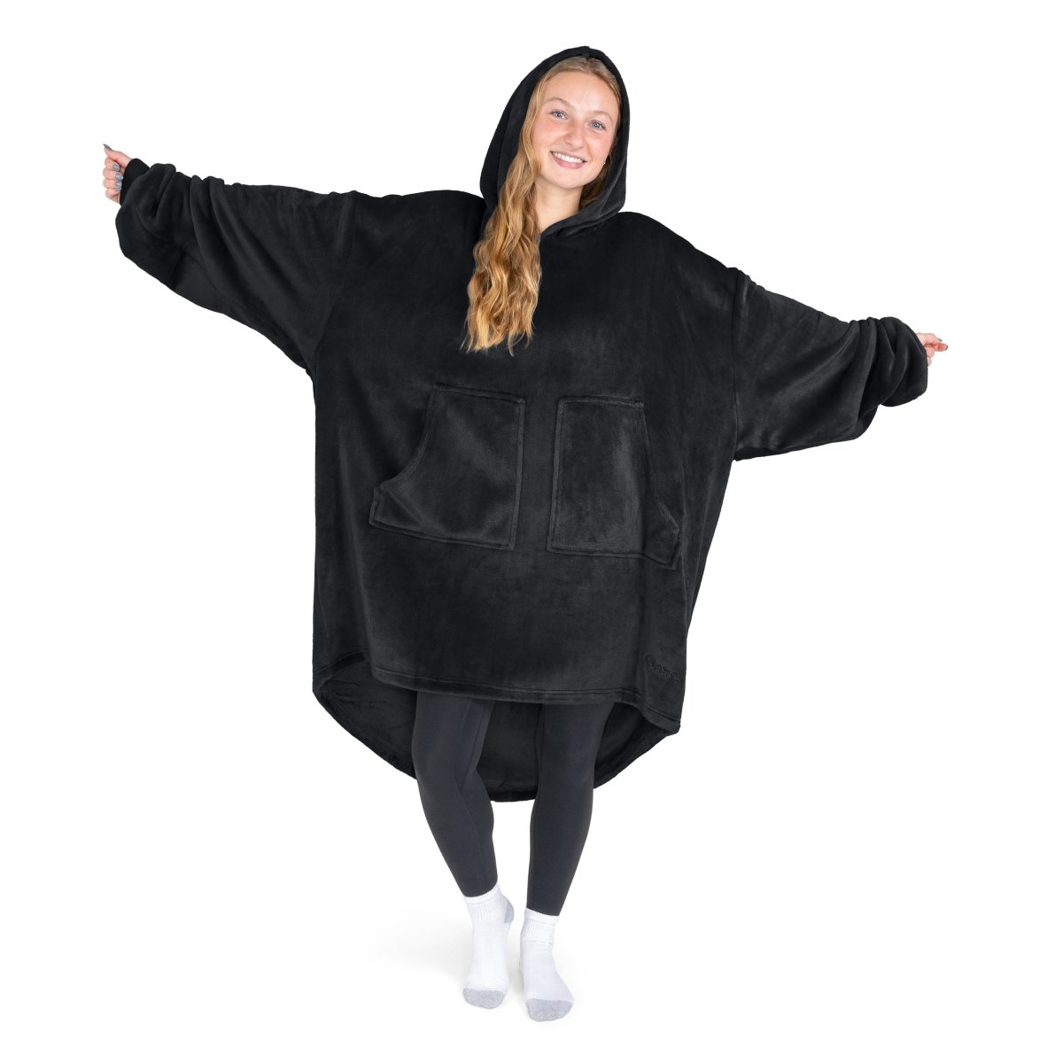 A woman has a hooded wearable blanket on