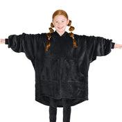 A girl is standing while wearing a microplush wearable blanket