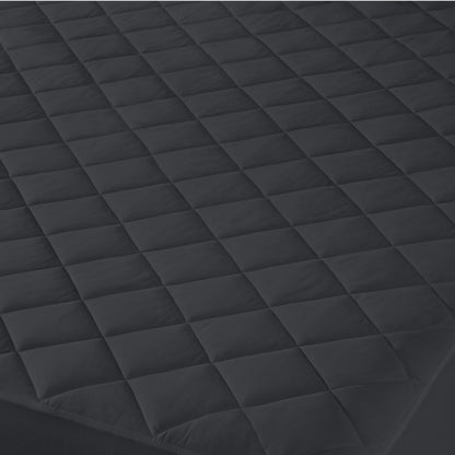 Close-up of a quilted mattress cover with a diamond pattern.