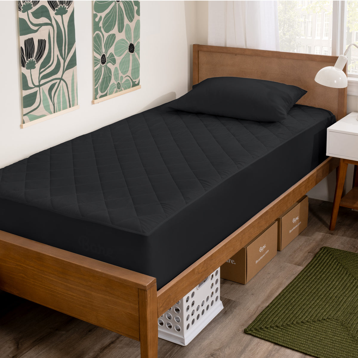Wooden bed with black mattress cover in a room with decorative elements.