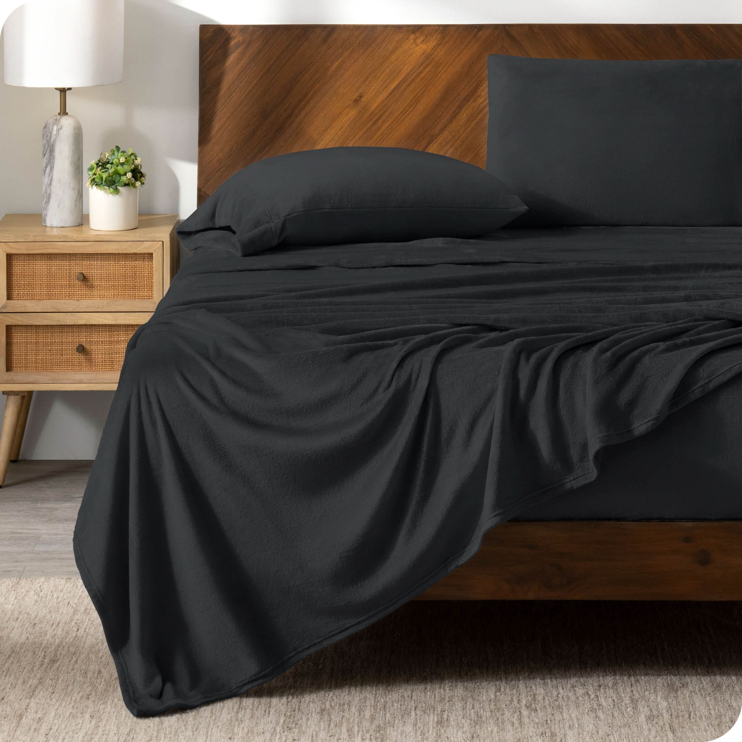 A microplush sheet set on a bed in a modern bedroom.