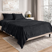 Neatly made bed in a well-lit bedroom.