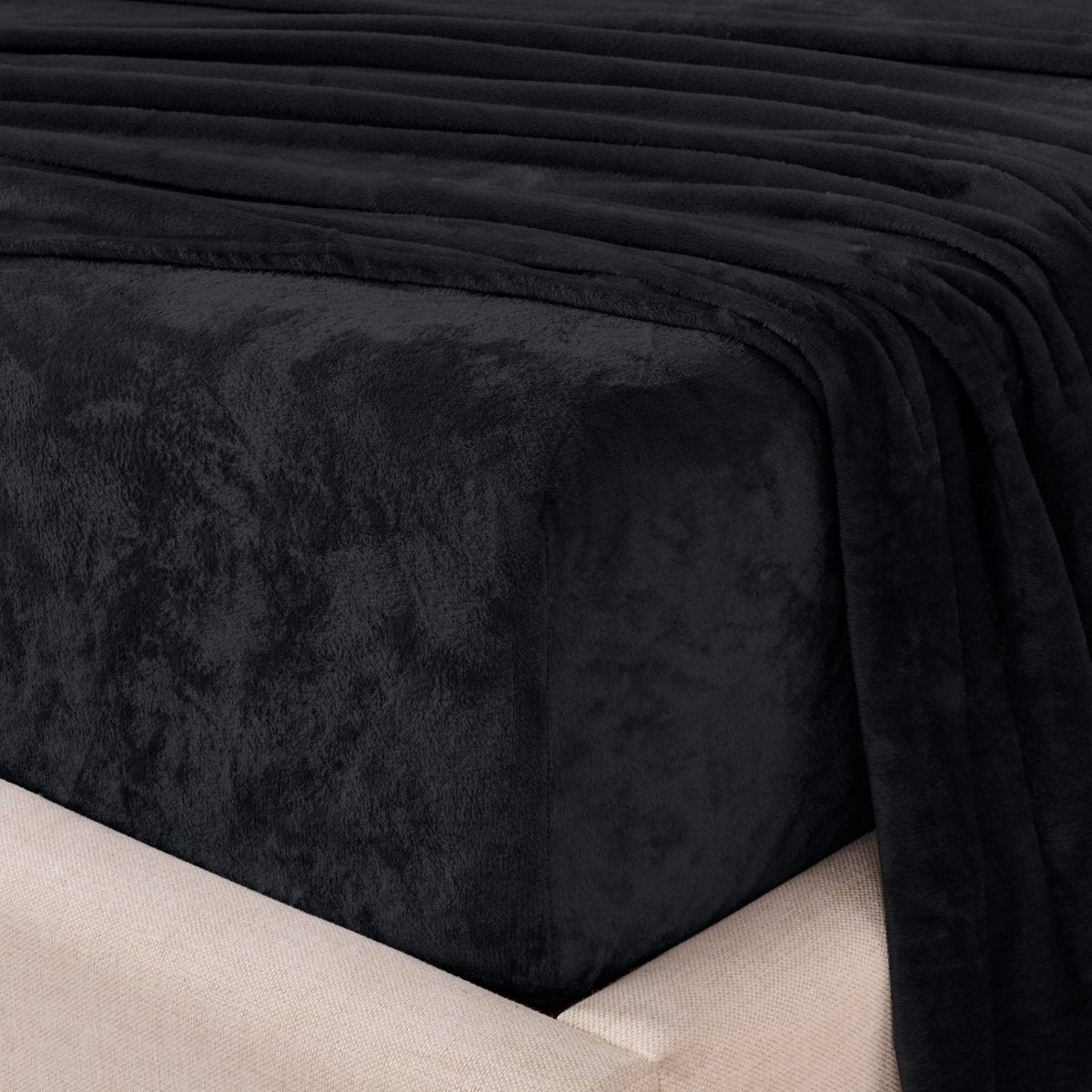 Close-up of the corner of a bed made with microplush sheets