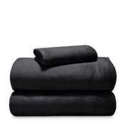 Stack of microplush sheets on a white background