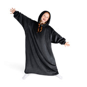 A girl has a hooded blanket on that is long enough to cover her legs