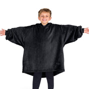 A boy wearing a blanket made of microplush, showcasing comfort and warmth.