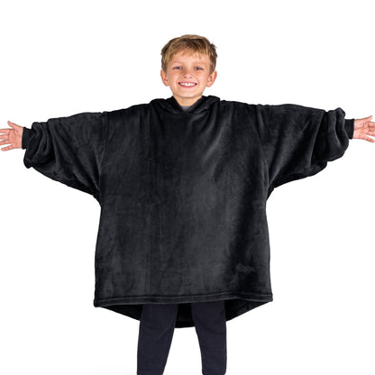 A boy wearing a blanket made of microplush, showcasing comfort and warmth.